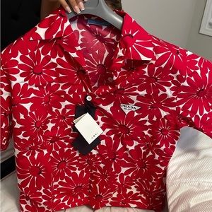 This is a Prada button up shirt , it’s brand new with tags on it